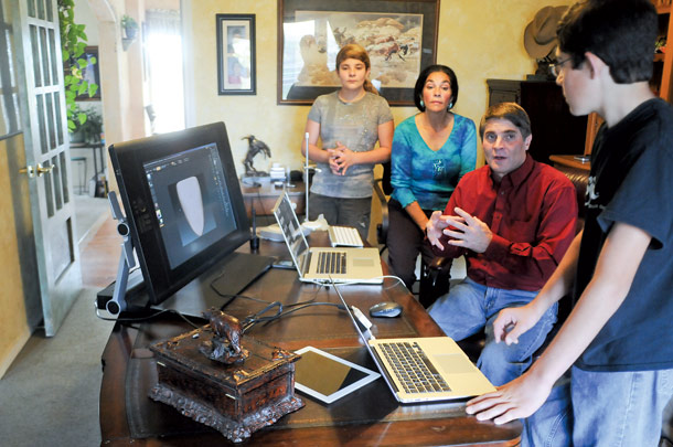 Family members Milana, Tina, Marc and Caleb Milisavljevich, left to right, demonstrate the software and hardware they use in 3D printing at their office.